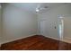Bedroom with hardwood floors, ceiling fan, and closet with white door at 16206 Diamond Bay Dr, Wimauma, FL 33598