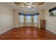 Cozy bedroom with a bay window, unique ceiling, and ceiling fan at 16206 Diamond Bay Dr, Wimauma, FL 33598