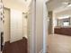 View of the custom walk in closet leading to the primary bath at 16206 Diamond Bay Dr, Wimauma, FL 33598