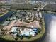 Aerial view of the Valencia Lakes community clubhouse, pool, parking and tennis courts on the lake at 16206 Diamond Bay Dr, Wimauma, FL 33598