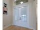 Foyer with double doors and artwork; view overlooking a scenic lake at 16206 Diamond Bay Dr, Wimauma, FL 33598