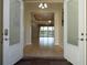 Open foyer showcasing hardwood floors and views to the living area and pool at 16206 Diamond Bay Dr, Wimauma, FL 33598