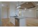 Bright kitchen with stainless steel appliances, white cabinets, and an island with a sink at 16206 Diamond Bay Dr, Wimauma, FL 33598
