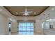 Open concept living room featuring a decorative ceiling, fan, and sliding glass doors to a pool at 16206 Diamond Bay Dr, Wimauma, FL 33598
