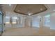 Open concept living room featuring decorative ceiling, view of kitchen, and entrance at 16206 Diamond Bay Dr, Wimauma, FL 33598