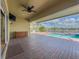Outdoor living featuring brick pavers, ceiling fan, bar, and scenic views of the lake and pool at 16206 Diamond Bay Dr, Wimauma, FL 33598