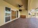 Enjoy the outdoor living space with brick pavers, ceiling fan, and adjacent to the pool and lake at 16206 Diamond Bay Dr, Wimauma, FL 33598