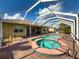 Relaxing screened-in pool with spa and brick paver deck, providing a luxurious outdoor living experience at 16206 Diamond Bay Dr, Wimauma, FL 33598