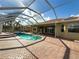 Screened-in pool with brick pavers and access to the spa and covered patio, offering a relaxing outdoor space at 16206 Diamond Bay Dr, Wimauma, FL 33598