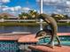 Close-up of a pool's edge featuring decorative tile and a dolphin statue at 16206 Diamond Bay Dr, Wimauma, FL 33598