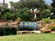 Picturesque waterfall and lush landscaping at the Valencia Lakes community, offering a tranquil and inviting atmosphere at 16206 Diamond Bay Dr, Wimauma, FL 33598