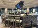 Stylish bar area with modern seating, a large countertop, ample lighting, and TVs for entertainment at 17520 Gawthrop Dr # 106, Lakewood Ranch, FL 34211