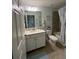 Well-lit bathroom featuring a white vanity, framed mirror, and combined shower and tub at 17520 Gawthrop Dr # 106, Lakewood Ranch, FL 34211