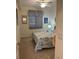 Cozy bedroom features a ceiling fan and a window with a light-filtering blind at 17520 Gawthrop Dr # 106, Lakewood Ranch, FL 34211