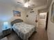 Bedroom with double closet and neutral color palette features a ceiling fan and beach-themed decor at 17520 Gawthrop Dr # 106, Lakewood Ranch, FL 34211