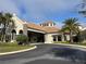 Elegant clubhouse with a circular driveway and lush landscaping at 17520 Gawthrop Dr # 106, Lakewood Ranch, FL 34211