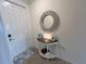 Inviting foyer with a decorative mirror, stylish table, and tiled flooring at 17520 Gawthrop Dr # 106, Lakewood Ranch, FL 34211