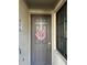 Charming front door adorned with a floral wreath and a modern security system at 17520 Gawthrop Dr # 106, Lakewood Ranch, FL 34211
