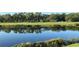 Scenic view of the golf course and pond in a serene, natural setting at 17520 Gawthrop Dr # 106, Lakewood Ranch, FL 34211