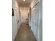 Well-lit hallway featuring tiled flooring, storage closets, and access to other rooms at 17520 Gawthrop Dr # 106, Lakewood Ranch, FL 34211