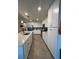 Spacious kitchen with white cabinets, tiled backsplash, stainless steel appliances, and a large island at 17520 Gawthrop Dr # 106, Lakewood Ranch, FL 34211