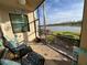 Relaxing screened lanai with comfortable seating overlooking a serene lake view at 17520 Gawthrop Dr # 106, Lakewood Ranch, FL 34211