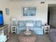 Comfortable living room with a blue sofa, stylish tables, and a decorative coffee table at 17520 Gawthrop Dr # 106, Lakewood Ranch, FL 34211