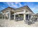 Inviting outdoor bar and patio area with ample seating and shade umbrellas at 17520 Gawthrop Dr # 106, Lakewood Ranch, FL 34211