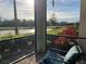 Covered patio with view of golf course, lake, and manicured landscaping at 17520 Gawthrop Dr # 106, Lakewood Ranch, FL 34211