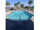 Community swimming pool with surrounding palm trees and lounge chairs at 17520 Gawthrop Dr # 106, Lakewood Ranch, FL 34211
