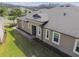 Home's backyard featuring a well-kept lawn, a covered patio, and lush landscaping at 19317 Hawk Valley Dr, Tampa, FL 33647