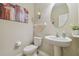 Powder room with a pedestal sink, neutral walls, and decorative accents at 19317 Hawk Valley Dr, Tampa, FL 33647