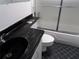 Bathroom featuring an updated sink and shower/bathtub combo with sliding glass doors at 2623 Seville Blvd # 111, Clearwater, FL 33764