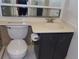 Bathroom with toilet, cabinet sink with brushed gold fixtures and hardware at 2623 Seville Blvd # 111, Clearwater, FL 33764