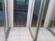 Bedroom with mirrored closet doors and hardwood floors at 2623 Seville Blvd # 111, Clearwater, FL 33764