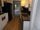Updated kitchen features black countertops, stainless steel dishwasher, and black appliances at 2623 Seville Blvd # 111, Clearwater, FL 33764