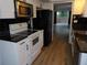 Updated kitchen with black countertops, black subway tile backsplash, and stainless steel microwave at 2623 Seville Blvd # 111, Clearwater, FL 33764