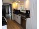 Updated kitchen features black countertops, stainless steel dishwasher, and white cabinets at 2623 Seville Blvd # 111, Clearwater, FL 33764