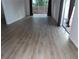 Open living room with hardwood floors and sliding glass doors to a balcony at 2623 Seville Blvd # 111, Clearwater, FL 33764