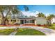 Charming one-story home featuring a well-maintained front yard with mature trees and a circular driveway at 3124 61St N Ln, St Petersburg, FL 33710