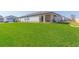 Lush backyard featuring a covered patio, perfect for outdoor entertaining and relaxation at 33277 Rosewood Bark Way, Wesley Chapel, FL 33545