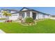 Inviting single-Gathering home with a lush front yard and covered entryway, perfect for welcoming guests at 33277 Rosewood Bark Way, Wesley Chapel, FL 33545
