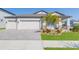 Charming single-story home featuring a three-car garage, well-manicured lawn, and inviting curb appeal at 33277 Rosewood Bark Way, Wesley Chapel, FL 33545