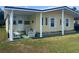 Charming yellow single-Gathering home featuring a covered front porch with ample seating at 35020 Colony Hills Dr, Zephyrhills, FL 33541