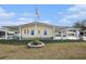 Lovely home with a covered parking area, green lawn, and charming landscaping, perfect for enjoying the outdoors at 35020 Colony Hills Dr, Zephyrhills, FL 33541