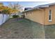 Side view of a fenced-in backyard with a lawn extending along the side of the house at 4357 50Th S Ave, St Petersburg, FL 33711