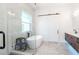 Bright bathroom with a soaking tub, glass enclosed shower, and modern vanity at 4604 W Lowell Ave, Tampa, FL 33629