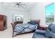Relaxing bedroom featuring a tray ceiling, king bed, dresser and lots of natural light at 4604 W Lowell Ave, Tampa, FL 33629