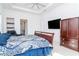 Inviting bedroom with tray ceiling, comfortable king bed, and ample storage space at 4604 W Lowell Ave, Tampa, FL 33629