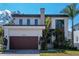 Contemporary two-story home featuring modern architecture, well-kept lawn, and a stylish brown garage door at 4604 W Lowell Ave, Tampa, FL 33629